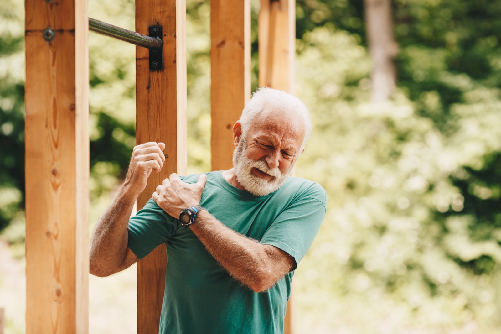 Senior man holding his shoulder in pain from a suspected rotator cuff injury