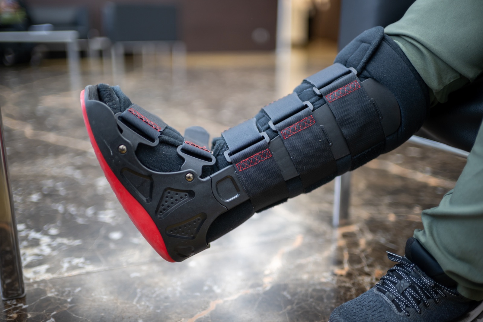 Person wearing a walking boot — a common part of stress fracture treatment to offload the injured bone